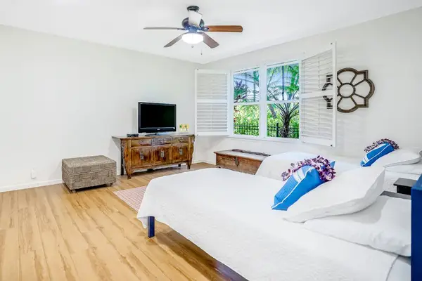 Extra living area with two single beds and a flat screen tv.