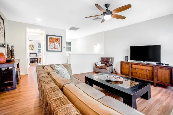 The living room is light-filled and boasts comfortable furniture (large sectional sofa and armchair) near a flatscreen Smart TV with cable. You're all set for movie nights with the family!