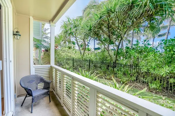 Private lanai surrounded by lush tropical paradise, vibrant flowers, and swaying palms—the perfect place to relax and soak in the island atmosphere.