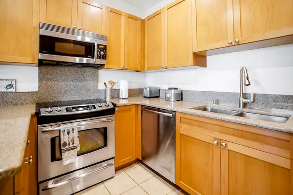 Fully-equipped kitchen, which is complete with all the modern appliances to make cooking a breeze, including a French-door fridge, stove, oven, dishwasher, microwave, and coffee maker.