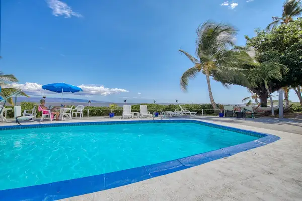 Resort pool offers refreshing swims beside beautiful tropical island scenery
