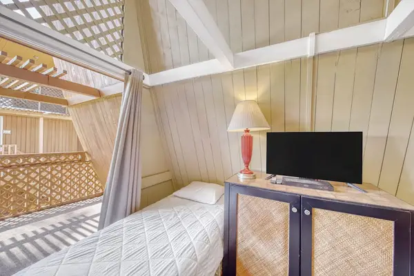 Cozy studio retreat featuring restful bed and TV for laid-back vacation evenings together