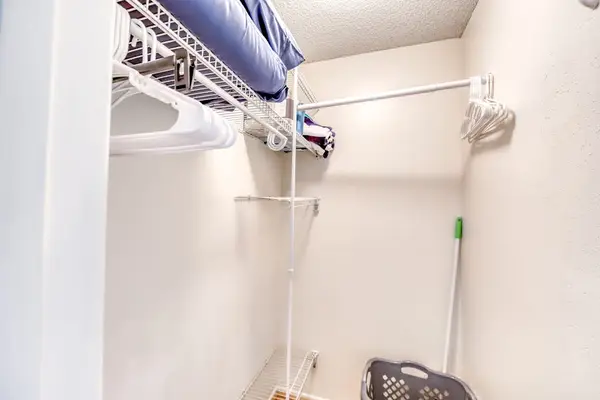 Walk-In Closet Space with Wire Shelving & Laundry Accessories