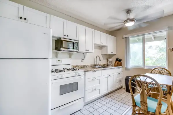 Bright Kitchen Area featuring White Appliances & Dining Nook