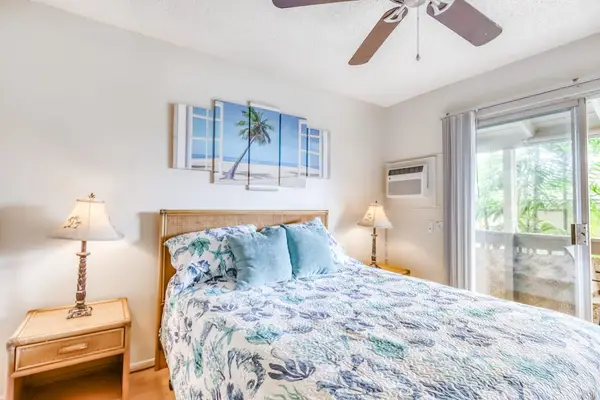 Cozy Bedroom featuring Tropical Floral Bedding, Ceiling Fan & Lanai Access