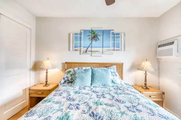 Cozy Queen Bed with Coastal Artwork & Matching Nightstands