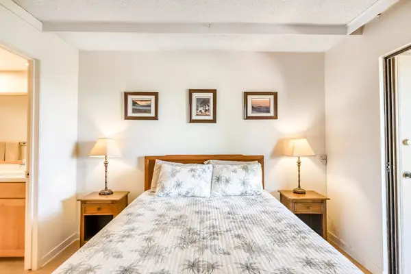 Comfortable queen bed promises restful nights after unforgettable island adventures together