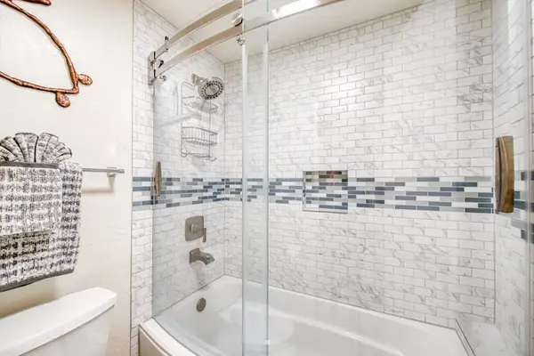 Modern walk-in shower with stylish tile accents