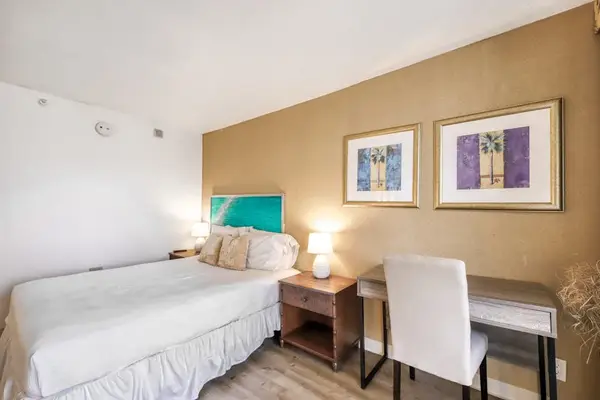 Comfortable bed beside a convenient workspace