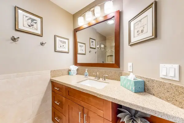 Tidy bathroom vanity offers practical comfort with bright tropical styling