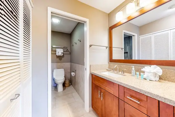 Bathroom vanity and shower area provide bright everyday guest comfort