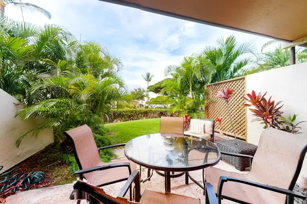 Covered patio seating overlooks tropical greenery for relaxed island mornings