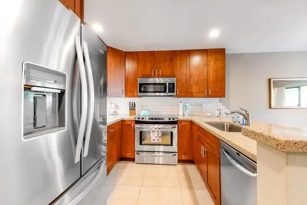 Well-equipped kitchen offers modern appliances for effortless island meal preparation