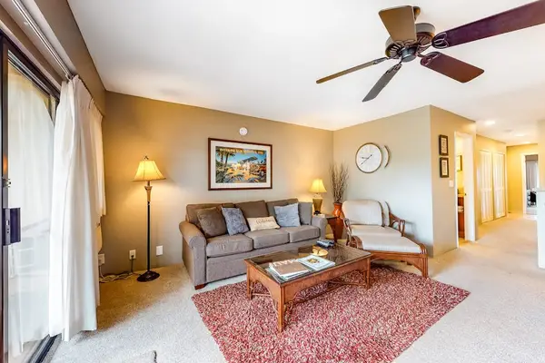 Warm living room setting blends comfortable furniture with island light