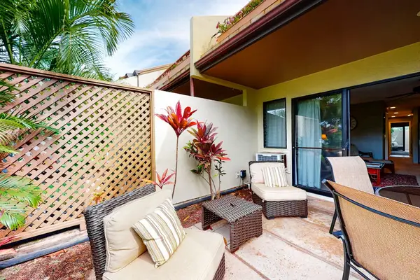 Covered patio seating extends comfortable living into lush tropical outdoors