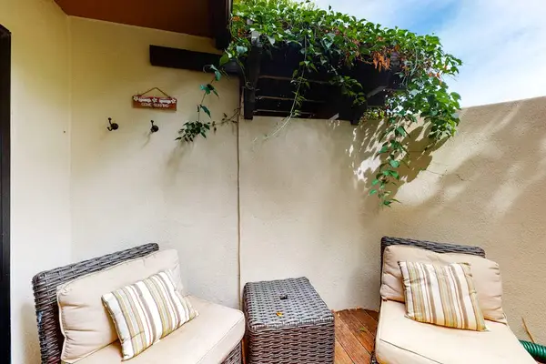 Patio lounge offers a shaded retreat surrounded by tropical greenery
