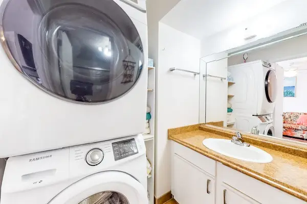 Bright bathroom with generous counter space, convenient drawers, and fresh towels ready for your stay