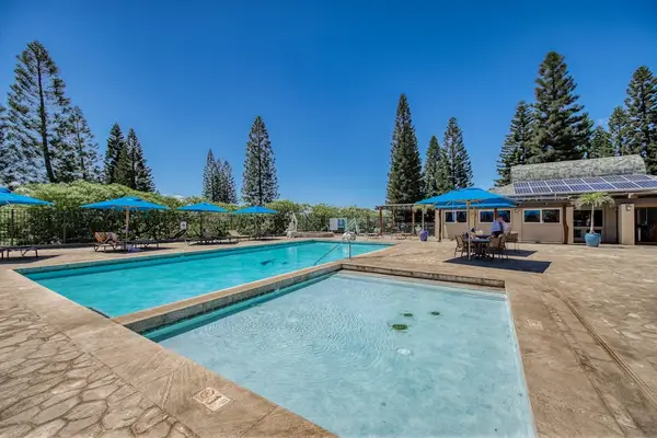 Resort-style pool surrounded by tropical landscaping.