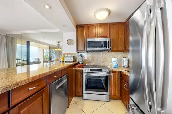 This newly remodeled kitchen with stainless steel appliances.  Large kitchen countertop for all the chef's prep needs and open to the dining room so that you are always with your company.