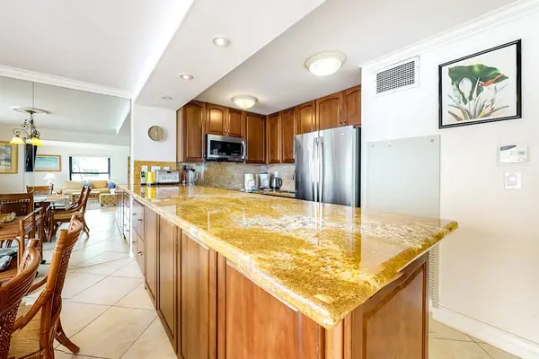 This newly remodeled kitchen with stainless steel appliances.  Large kitchen countertop for all the chef's prep needs and open to the dining room so that you are always with your company.