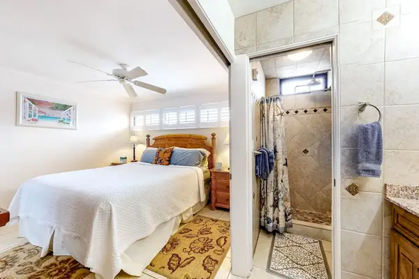 Master bedroom with king bed and an en-suite bathroom.