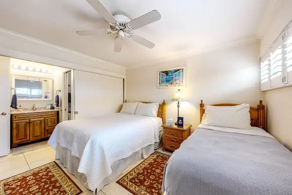 Guest room with queen and single bed with en-suite bathroom.