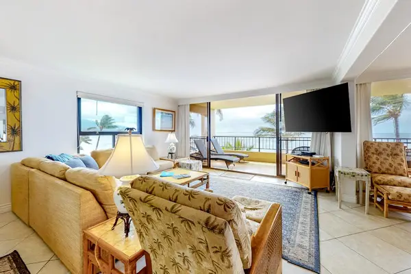 This large living room with a comfortable sectional with views from the open sliders of the lanai.  Turquoise waters as far as the eye could see.  Flat screen tv for relaxing movie nights in for the night.