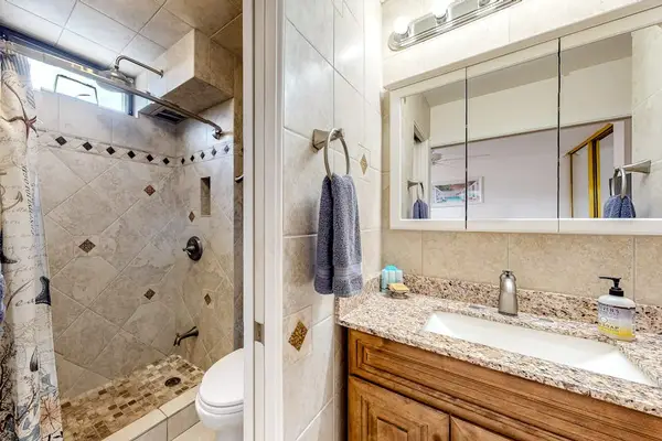 Master bathroom with newly remodeled walk-in tiled shower.