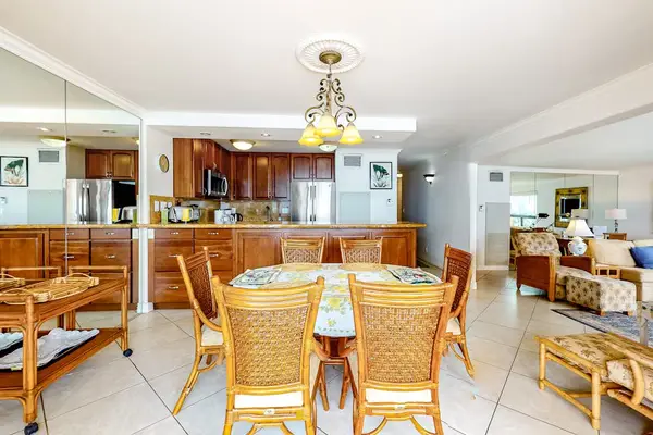 Dining room table with seating for six and open to the kitchen and you can feel the ocean breeze when you open the sliders to the lanai.