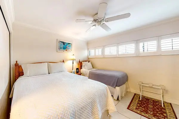 Guest room with queen and single bed with en-suite bathroom.