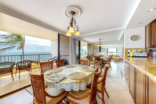 Dining room table with seating for six and open to the kitchen and you can feel the ocean breeze when you open the sliders to the lanai.