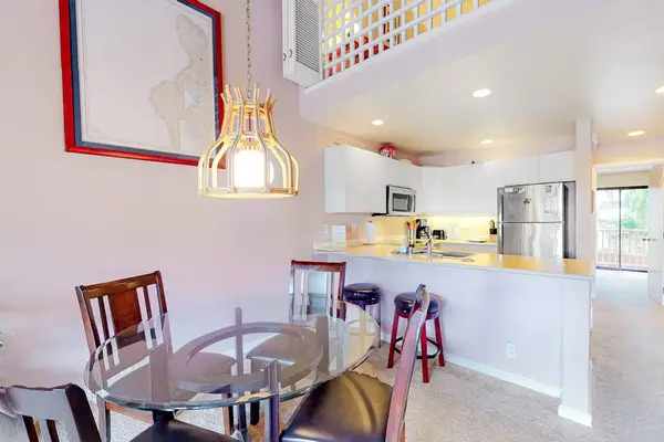 Kitchen dining area showcases modern appliances counters and breakfast seating