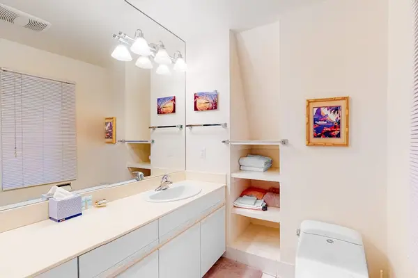 Bathroom includes dual vanity mirrors bathtub and convenient storage