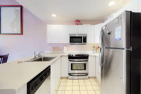 Kitchen showcases stainless appliances bright counters and convenient cooking workspace