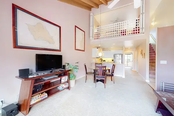 Living room features television seating and inviting open loft-style architecture
