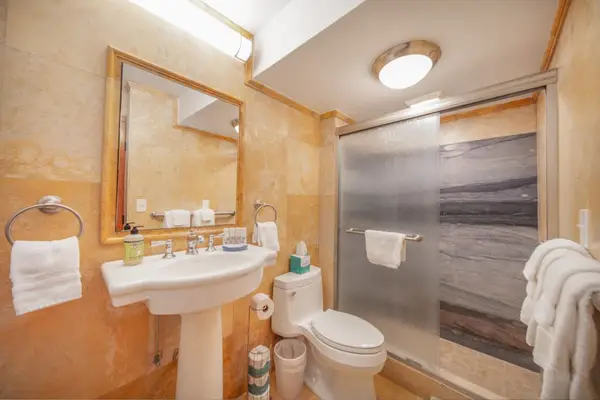 Full bathroom with a walk-in shower, fresh towels, and complimentary essentials for a comfortable stay.