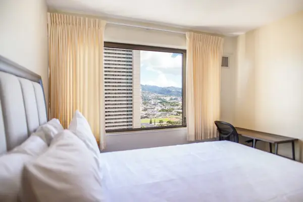 Enjoy relaxing mountain views from the bright bedroom featuring a dedicated workspace and comfortable accommodations.