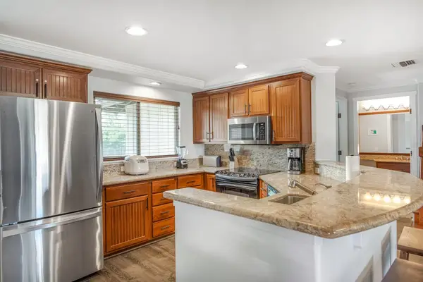 Stainless steel kitchen with a large island for added counter space.