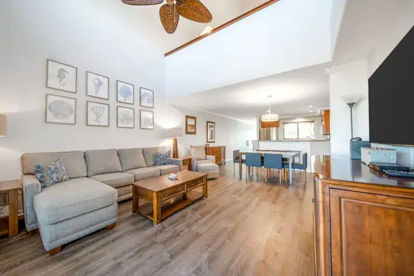 Living room with flat screen tv open to the dining room.
