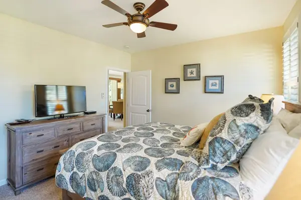 Queen bedroom with soft lighting and cozy furnishings