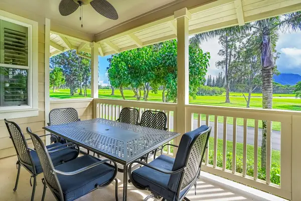 Covered porch with outdoor dining, surrounded by greenery