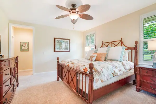 Primary bedroom with a comfortable bed and ceiling fan