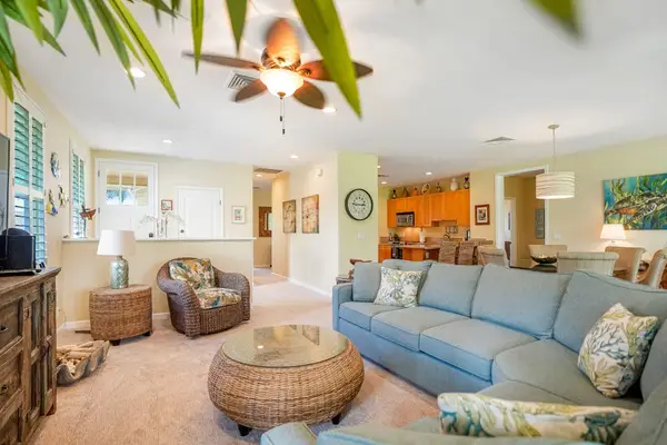 Comfortable living room with plush seating and ceiling fan
