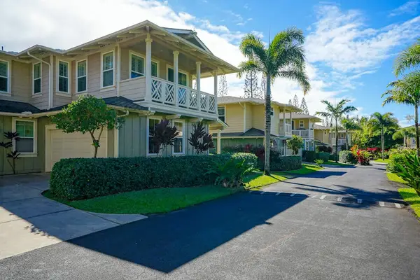 Tree-lined street with tropical landscaping throughout the community