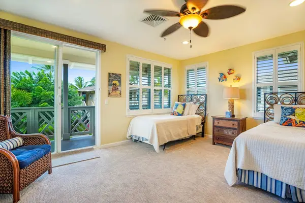 Bright twin bedroom with sliding door access to the lanai