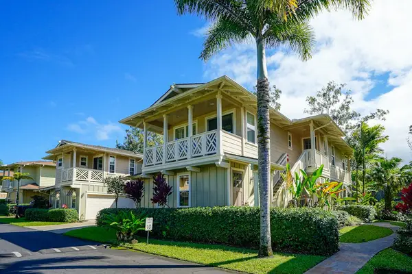 Two-story building surrounded by tropical landscaping