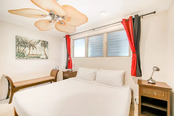 Inviting bedroom with ceiling fan offers cool comfort for peaceful nights and restful mornings