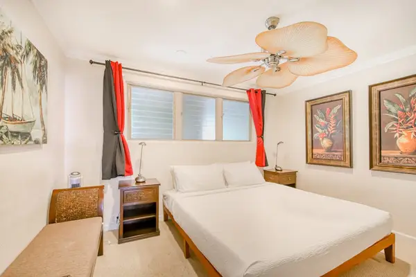 Thoughtfully furnished bedroom with ceiling fan delivers a cool relaxing retreat for every guest
