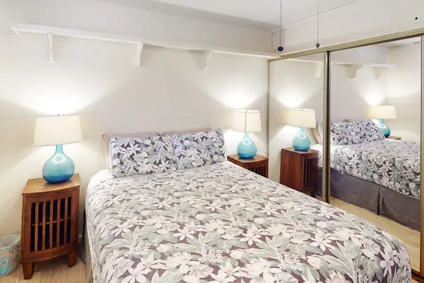 Queen bedroom offers floral bedding twin nightstands and ceiling fan
