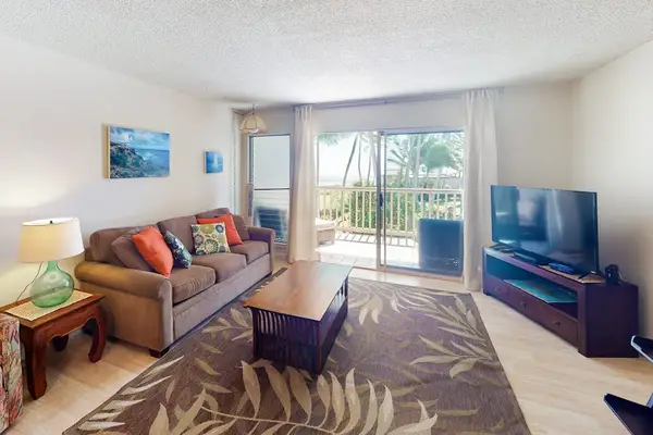 Living room combines television seating and bright sliding-door views outdoors
